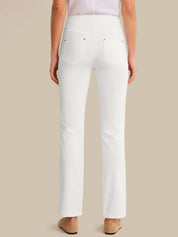 White pants worn by a person on a beige background