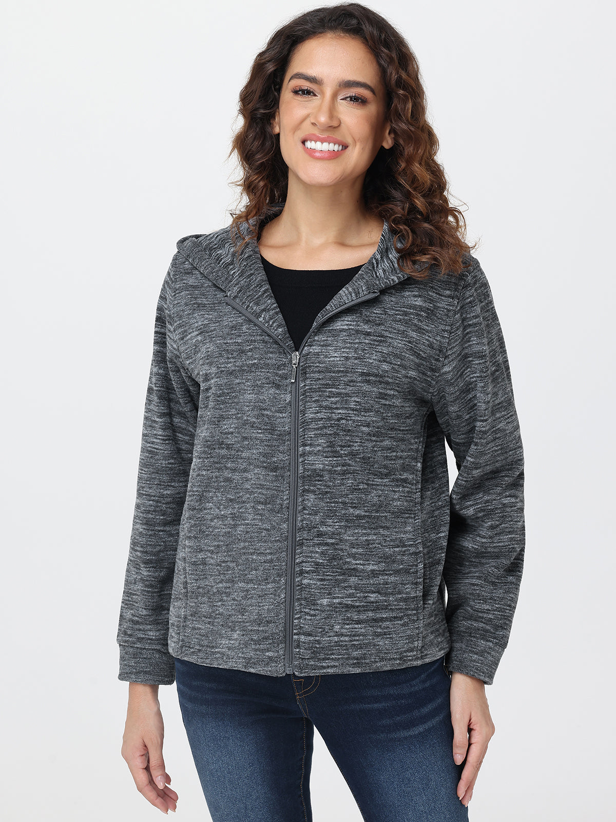 Woman wearing a gray zip-up hoodie on a white background
