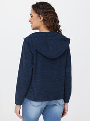 Woman wearing a blue hoodie and jeans on a white background