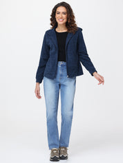 Woman wearing a navy blue jacket and light blue jeans on a white background