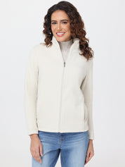 Woman wearing a cream jacket over a gray turtleneck on a white background