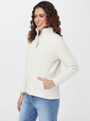 Woman wearing a cream-colored jacket on a white background