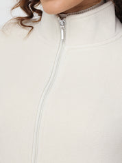 Close-up of a beige fleece jacket with a zipper