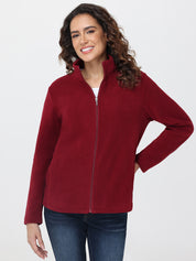 Woman wearing a red fleece jacket on a white background