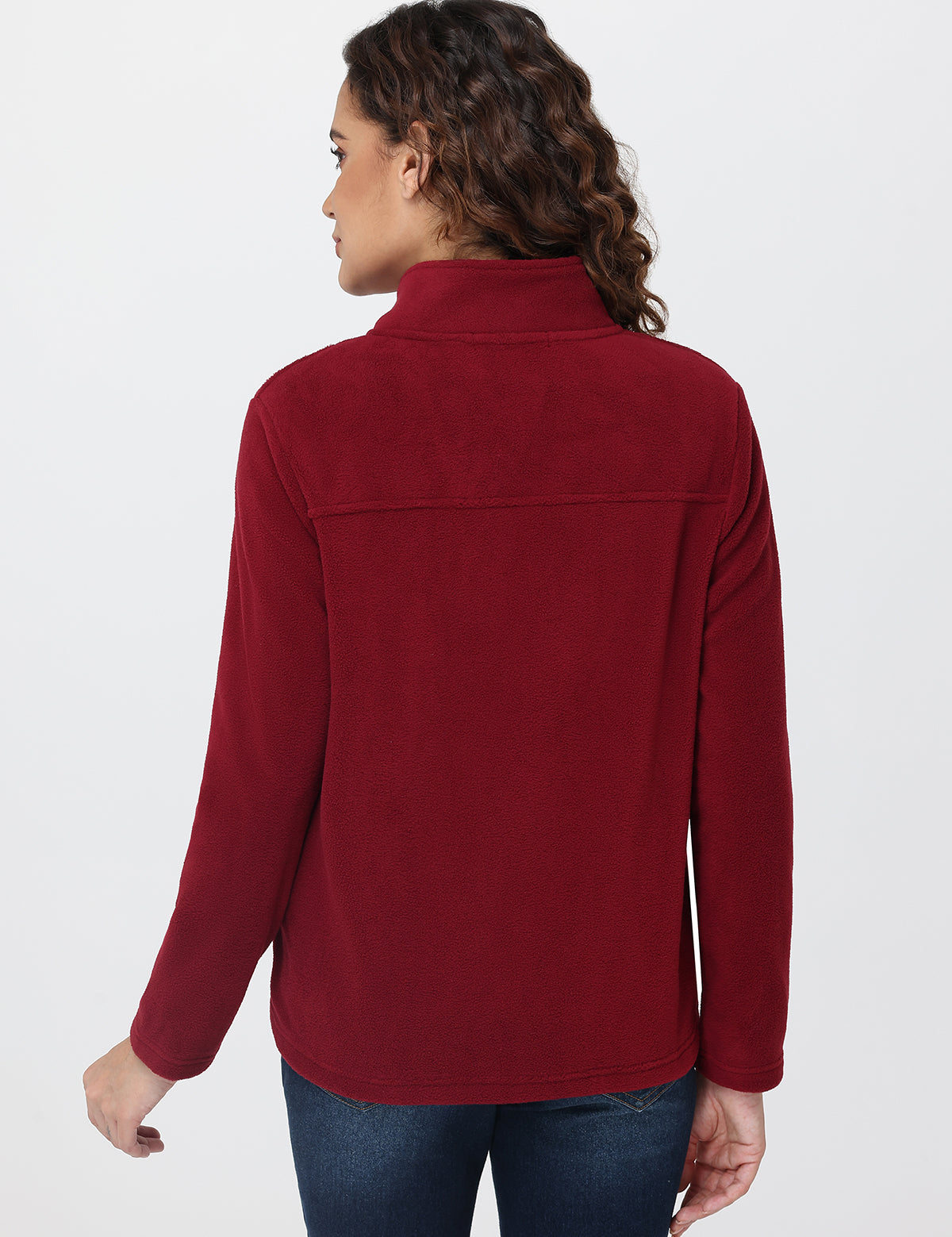 Person wearing a red fleece jacket on a white background