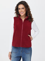 Woman wearing a red fleece vest over a white shirt on a white background