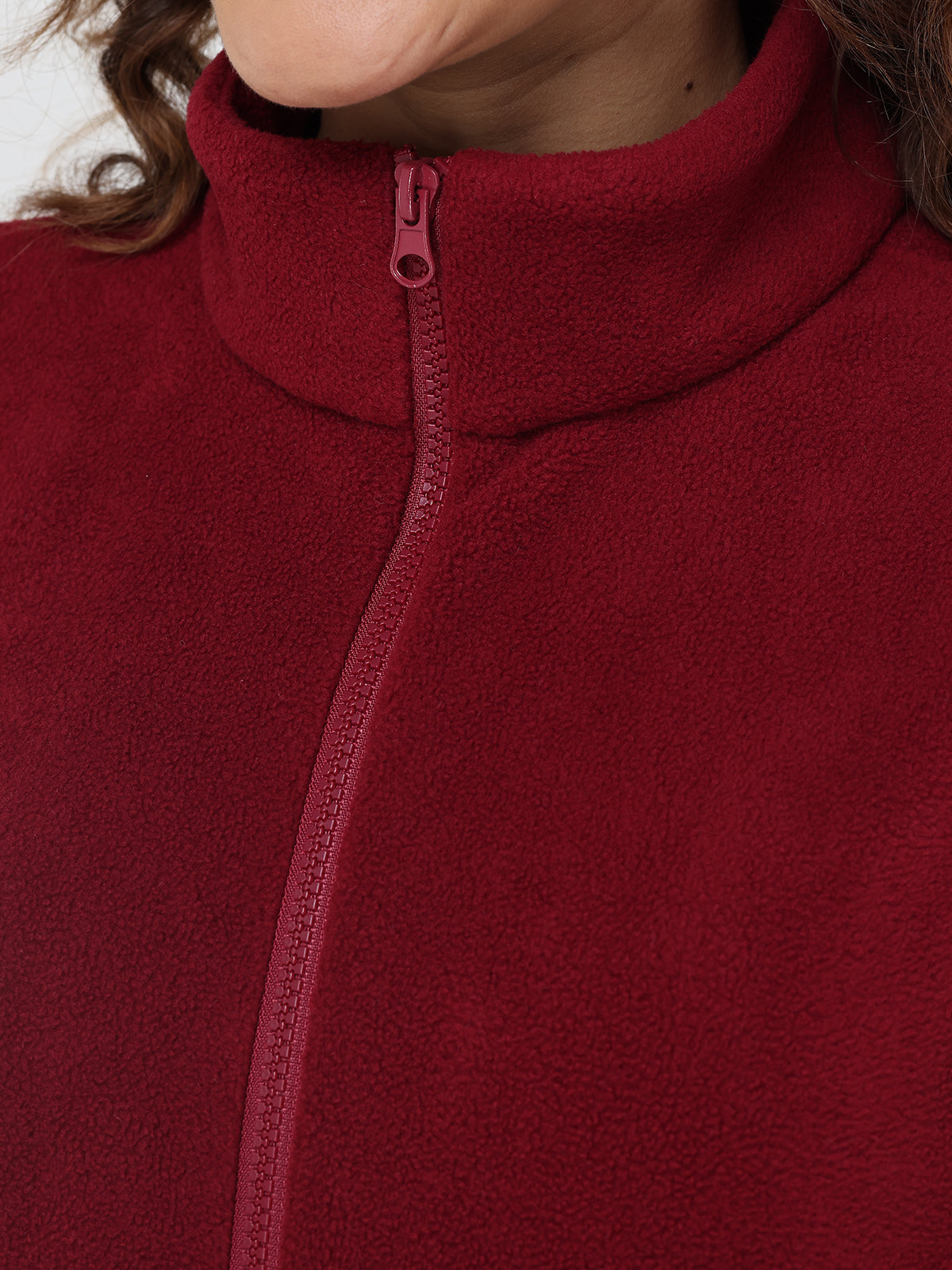Close-up of a red fleece jacket with a zipper