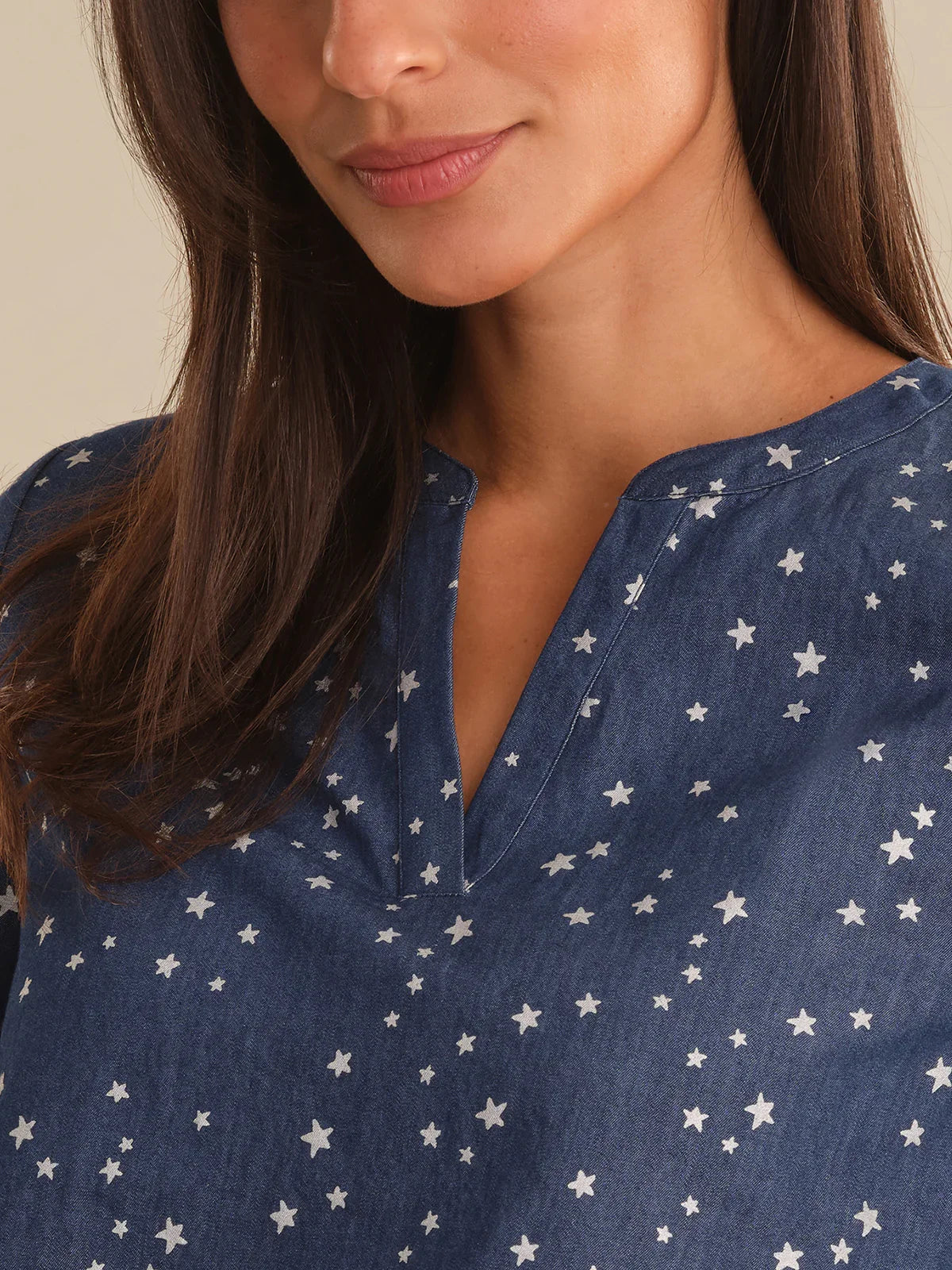 Woman wearing a blue shirt with white star pattern