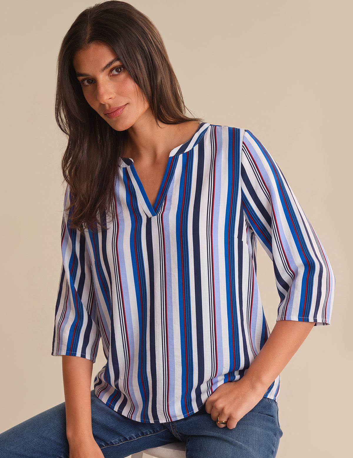 Woman wearing a striped shirt with a neutral background
