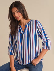 Woman wearing a striped shirt with a neutral background
