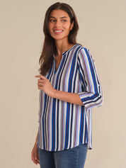 Woman wearing a striped shirt with a beige background