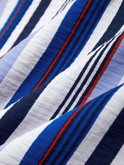 Close-up of a fabric with blue, white, and red horizontal stripes.