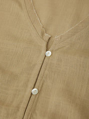 Close-up of a brown shirt with buttons on a textured fabric background