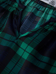 Green and black plaid shorts with a brand label on the waistband.