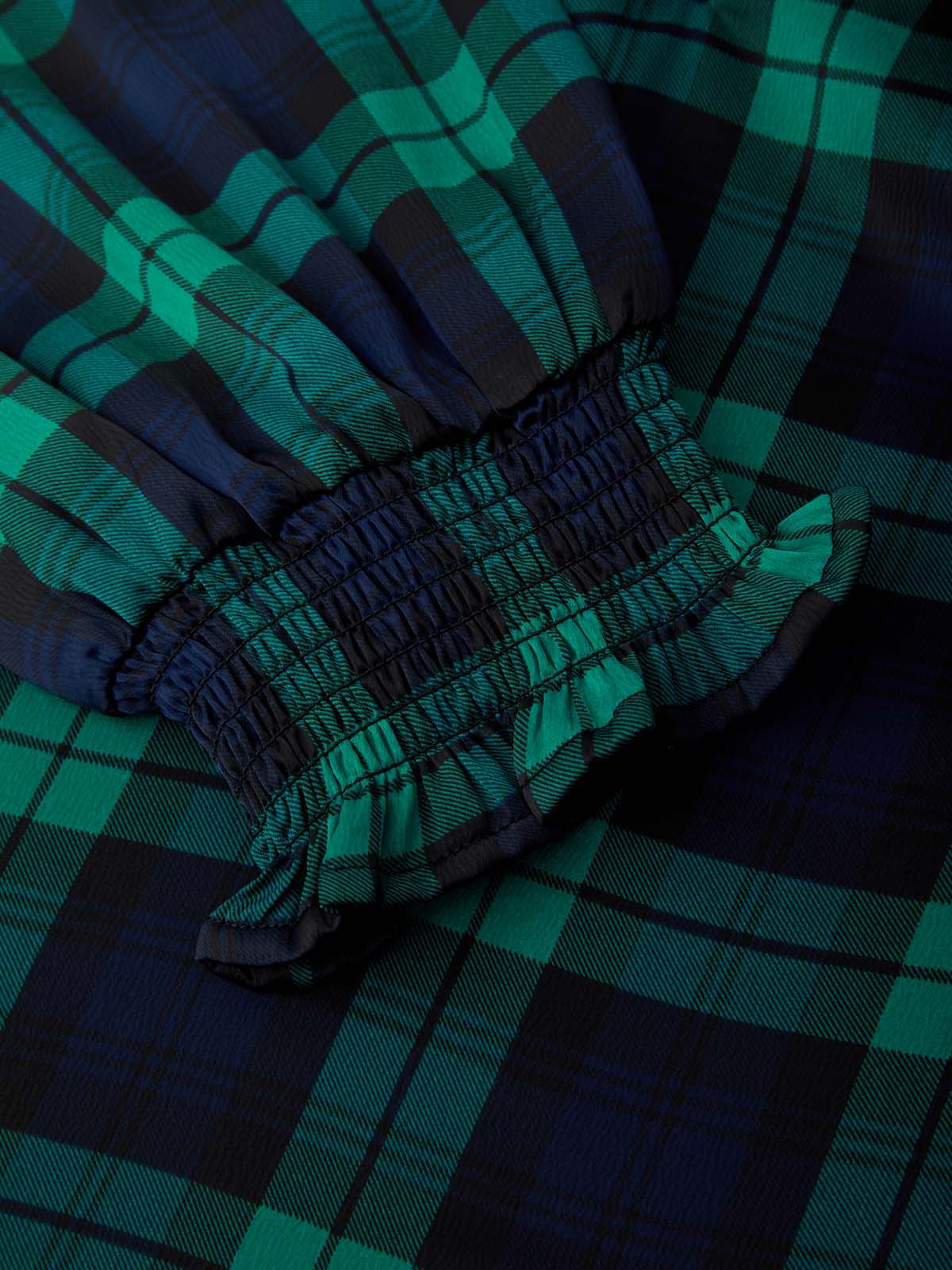 Close-up of green and blue plaid fabric with a focus on texture and pattern.