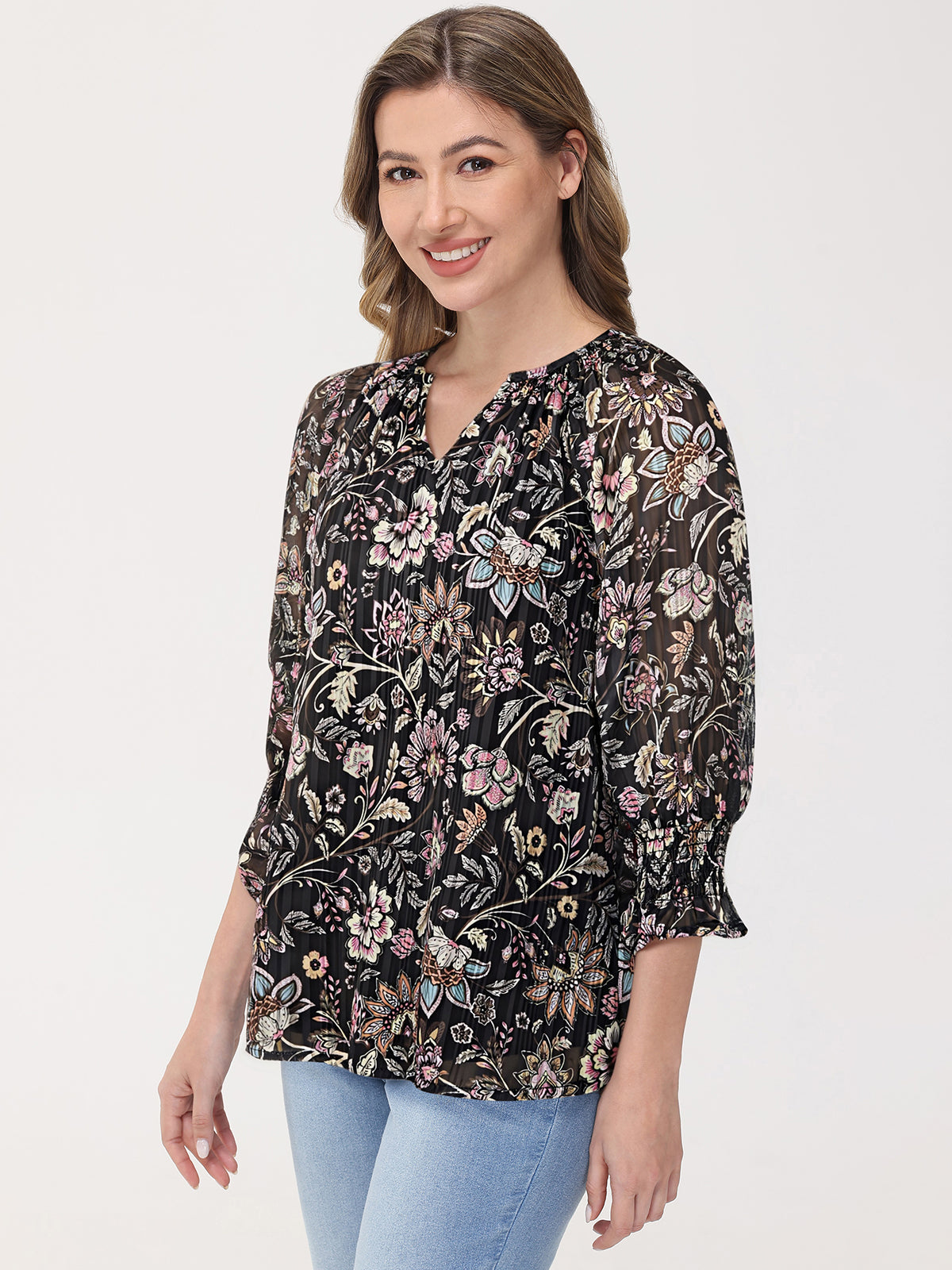 Woman wearing a floral blouse with a plain background