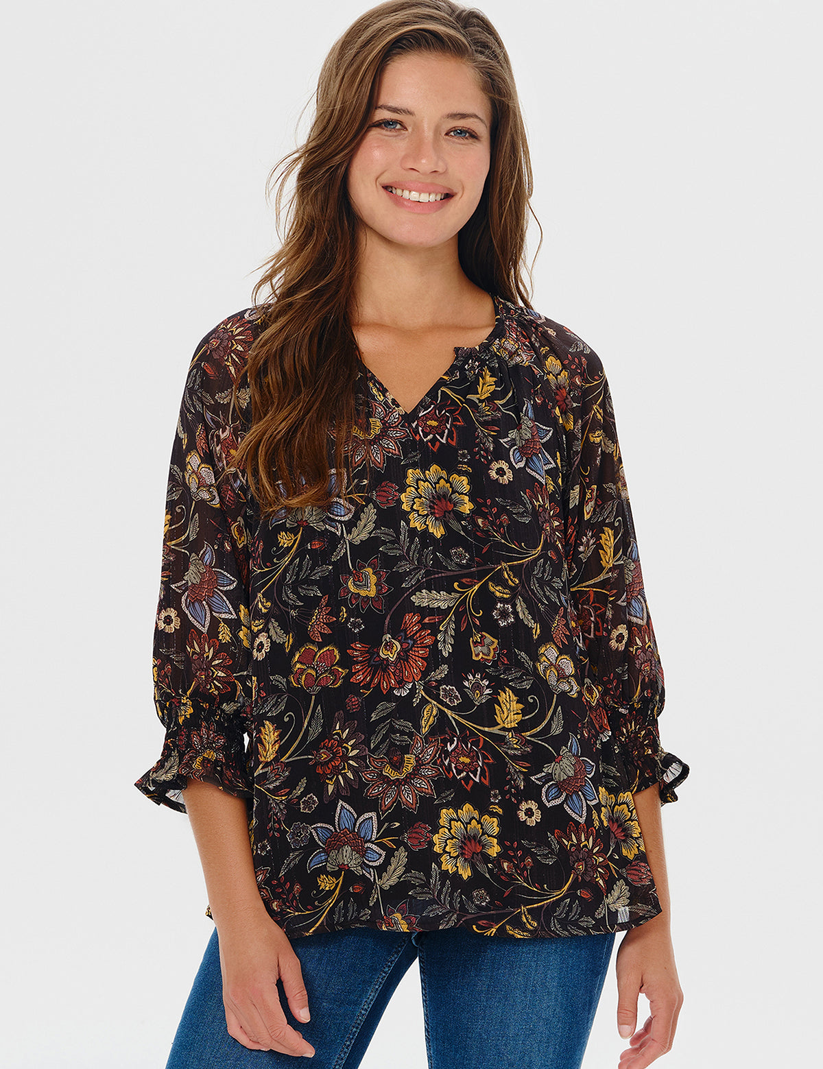 Woman wearing a floral blouse with a plain background