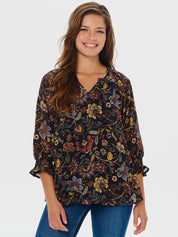 Woman wearing a floral blouse with a plain background