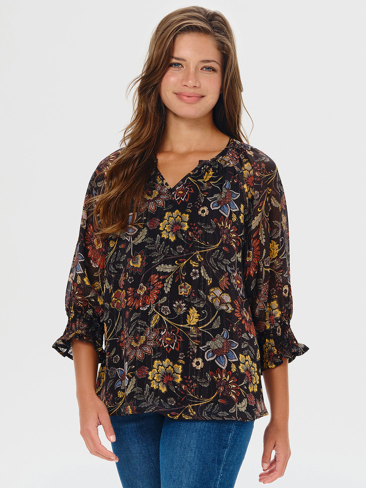 Woman wearing a floral blouse with a plain background