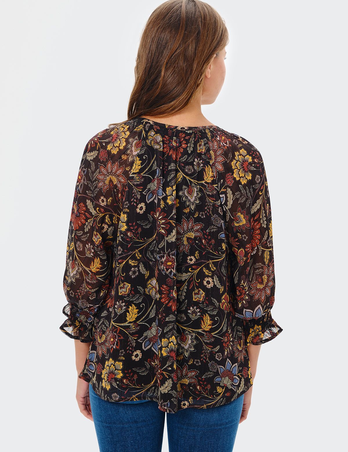 Woman wearing a floral blouse with a white background