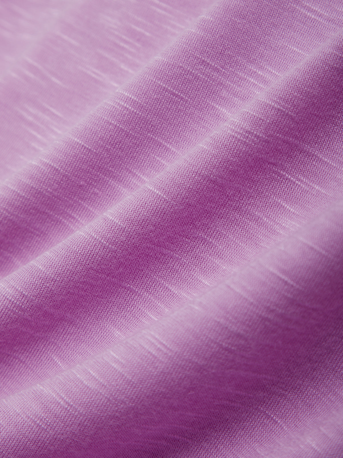 Close-up of purple fabric with a textured pattern