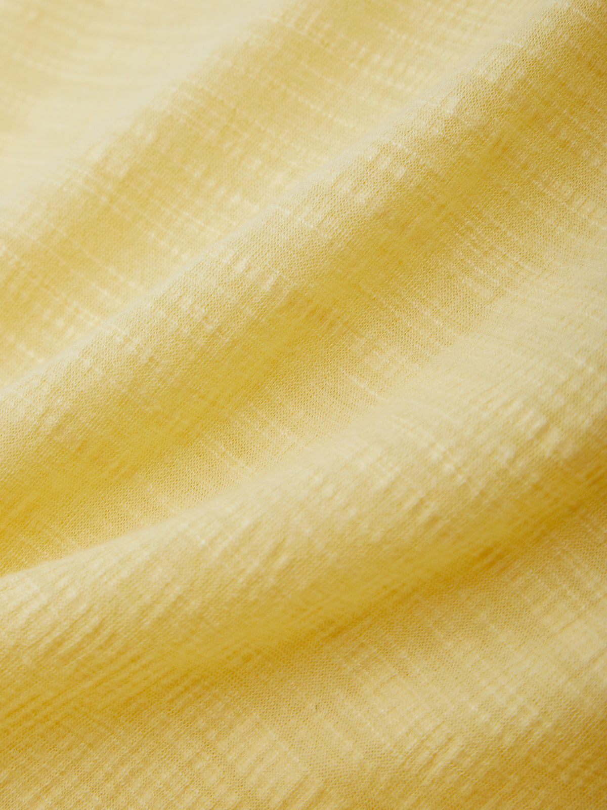 Close-up of textured yellow fabric