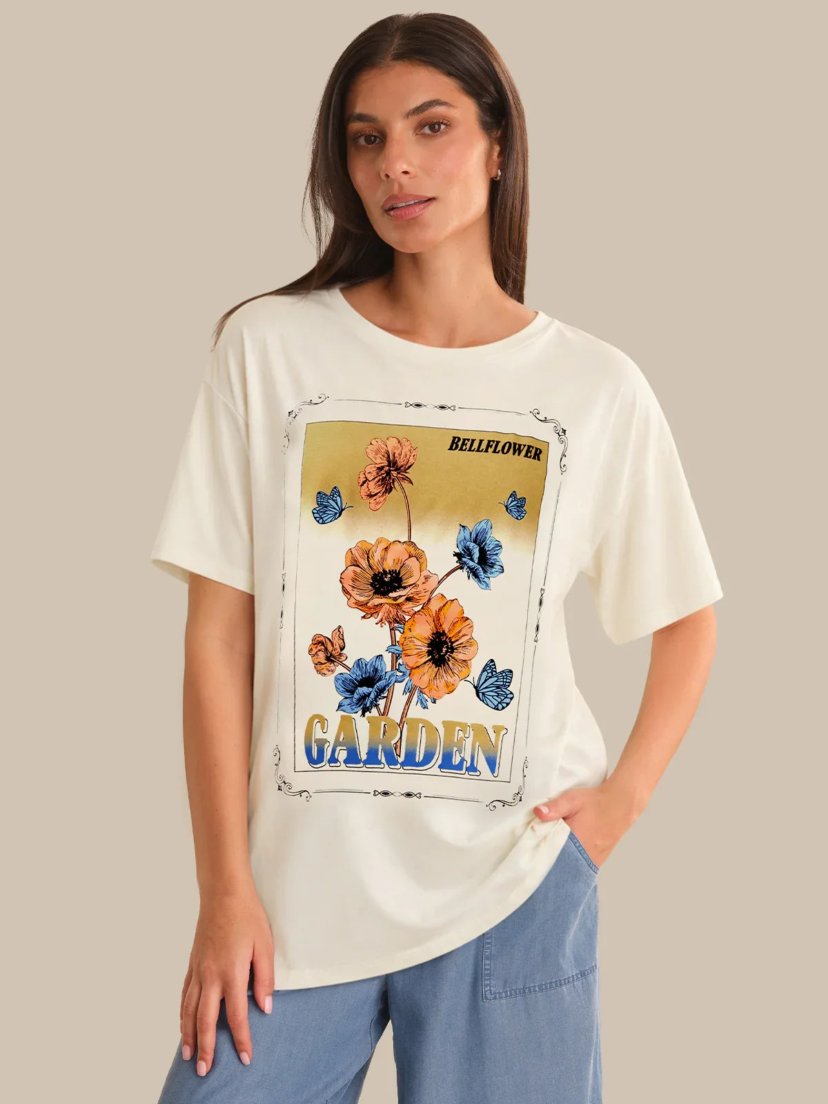 Woman wearing a white t-shirt with a floral graphic and text on a beige background