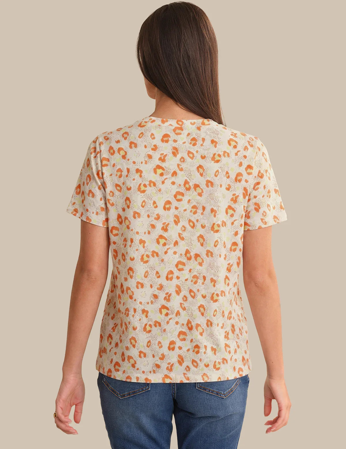 Person wearing a leopard print t-shirt against a beige background