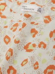 Fabric with orange and yellow pattern and '89th Madison' label.