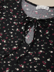 Floral patterned dress with a tie neckline and visible label.