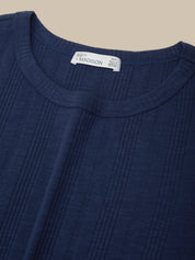 Close-up of a blue garment with a brand label on a beige background