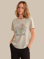 Woman wearing a beige t-shirt with floral design and 'Modern Victorian' text on a beige background