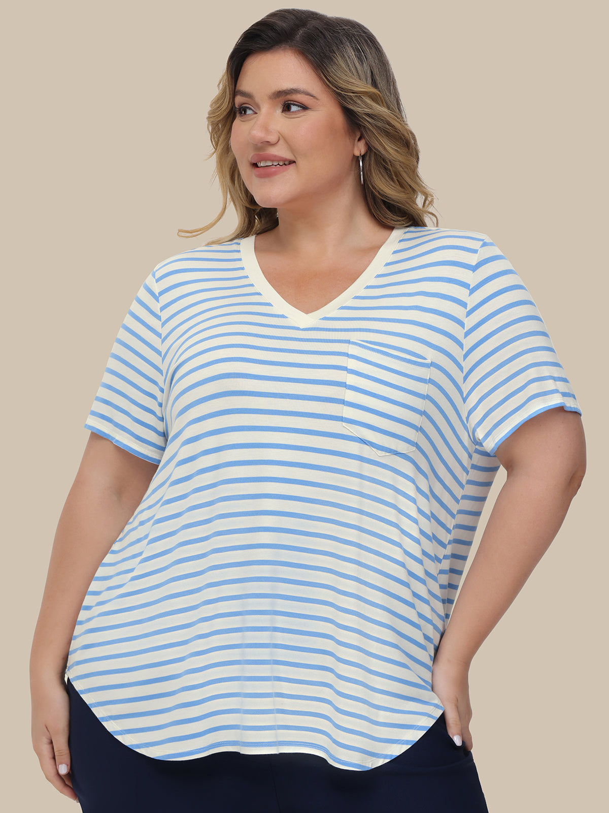 Woman wearing a blue and white striped t-shirt against a beige background