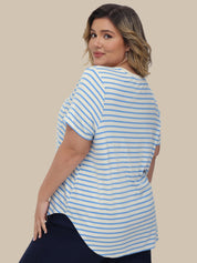 Woman wearing a blue and white striped shirt against a beige background