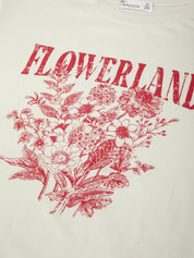 White t-shirt with red floral design and 'FLOWERLAND' text on a white background