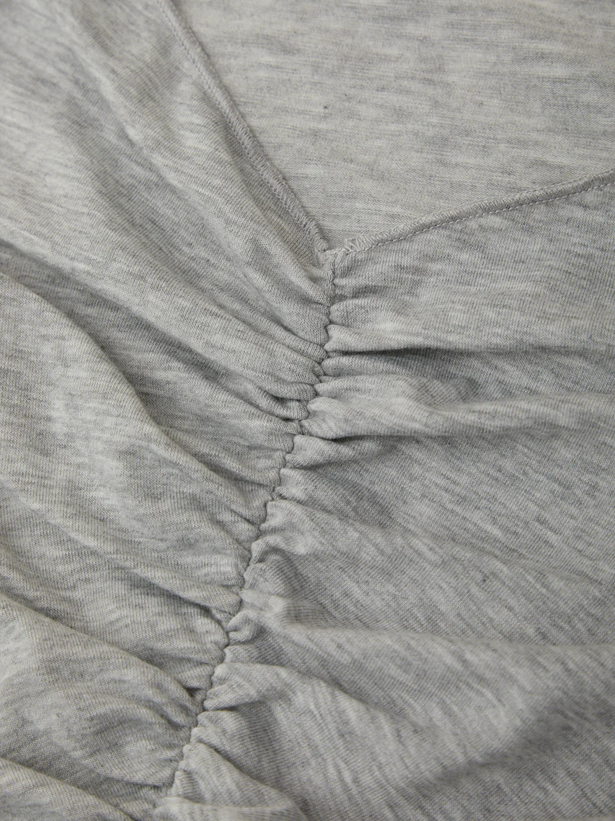 Close-up of gray fabric with a focus on texture and stitching.