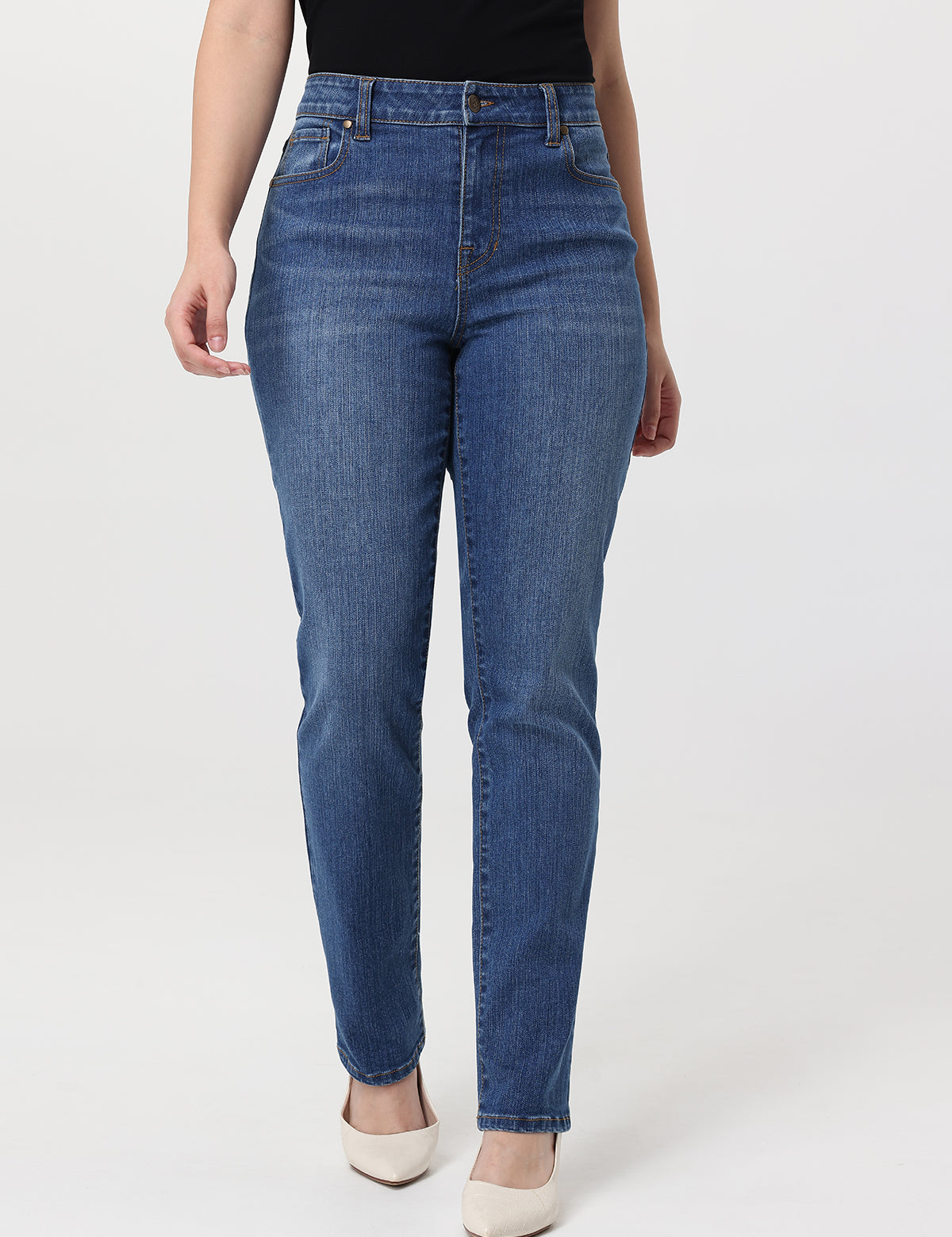 Person wearing blue jeans on a white background