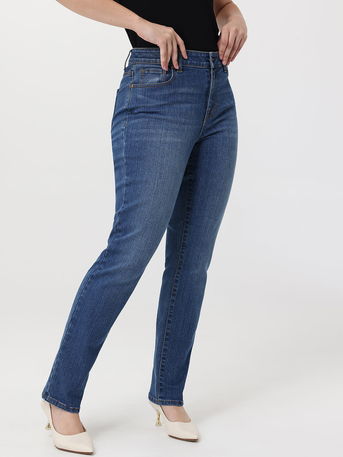 Blue jeans worn by a person on a white background
