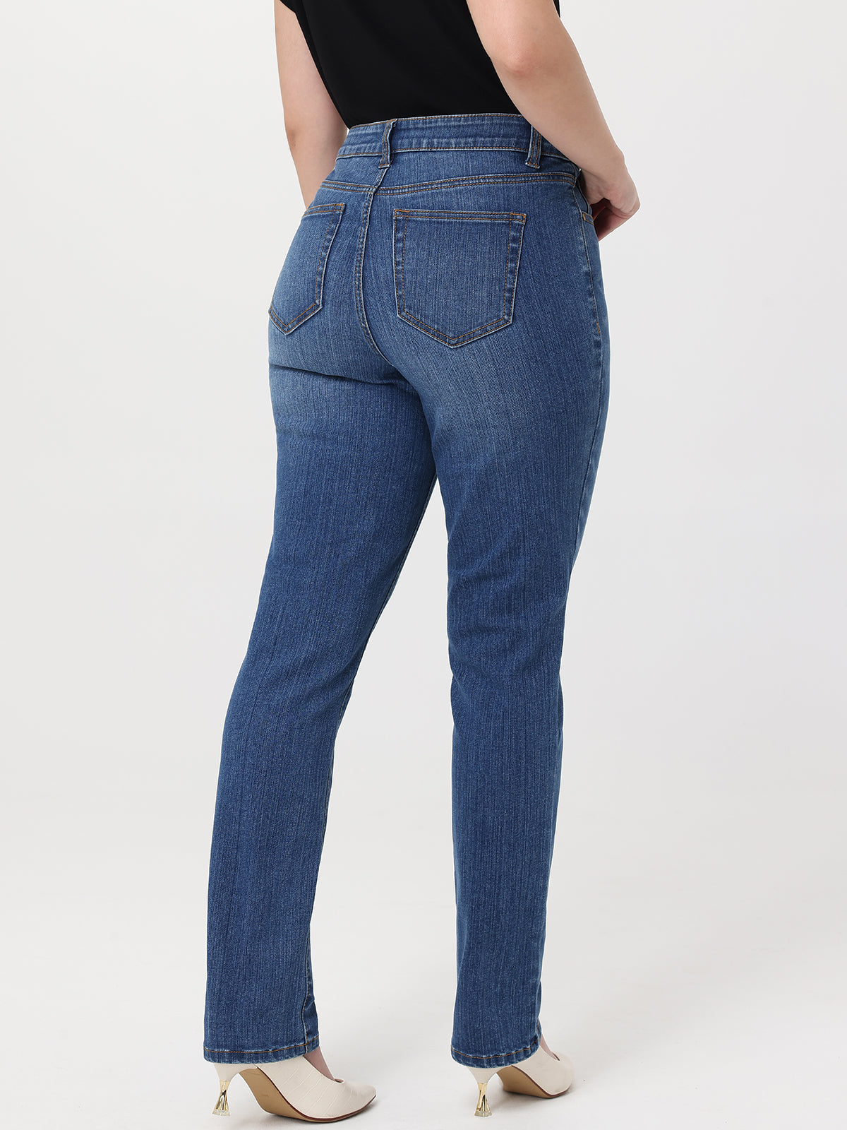 Person wearing blue jeans on a white background