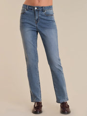 Blue jeans worn by a person on a beige background