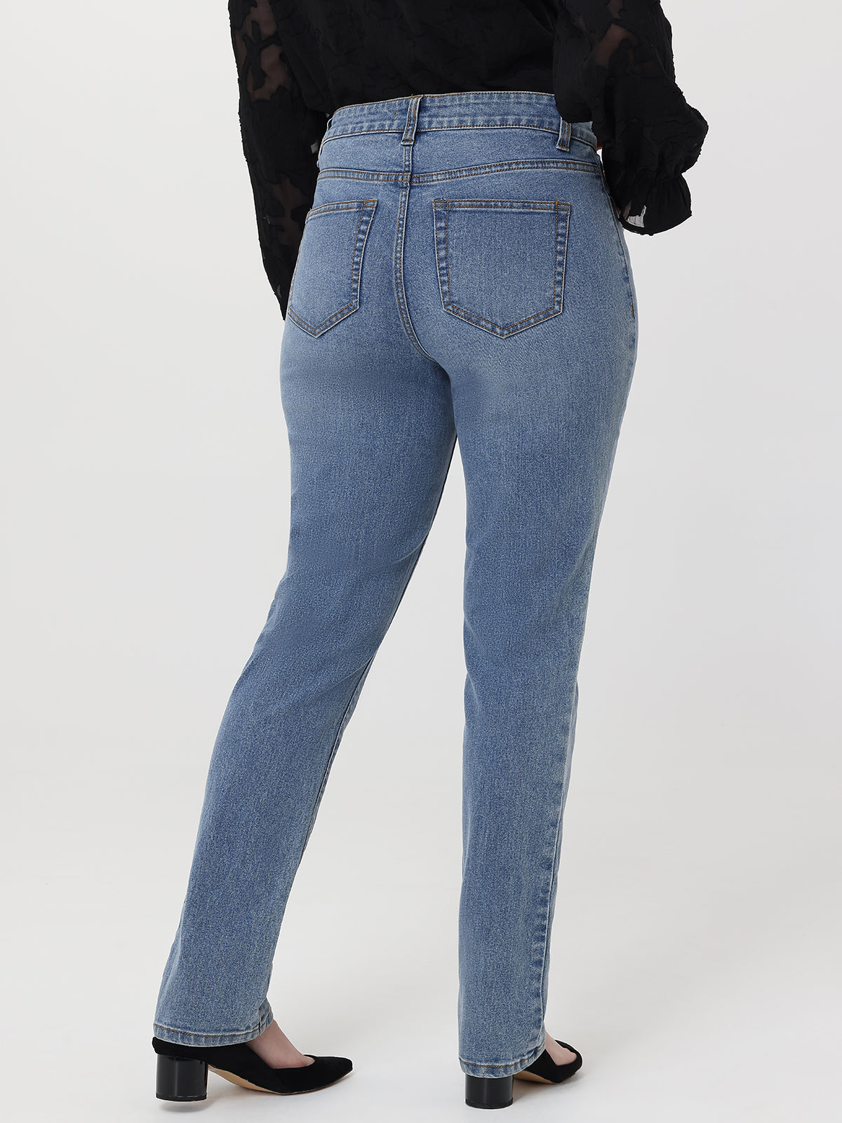 Blue jeans worn by a person on a white background
