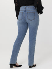Blue jeans worn by a person on a white background