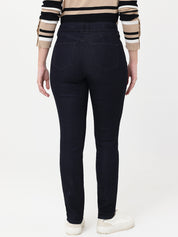 Person wearing navy jeans with a striped sweater on a white background