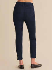 Navy blue pants worn by a person on a beige background