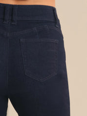Navy blue jeans with a beige background