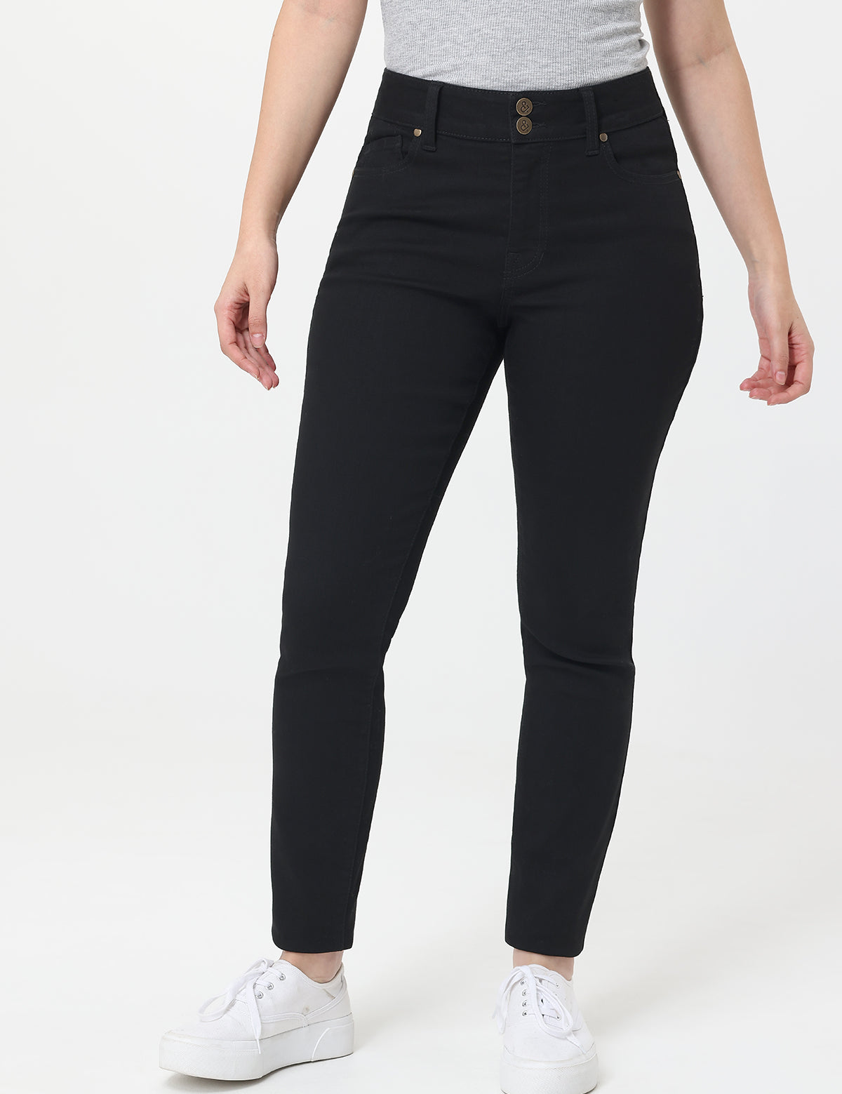 Person wearing black jeans on a white background