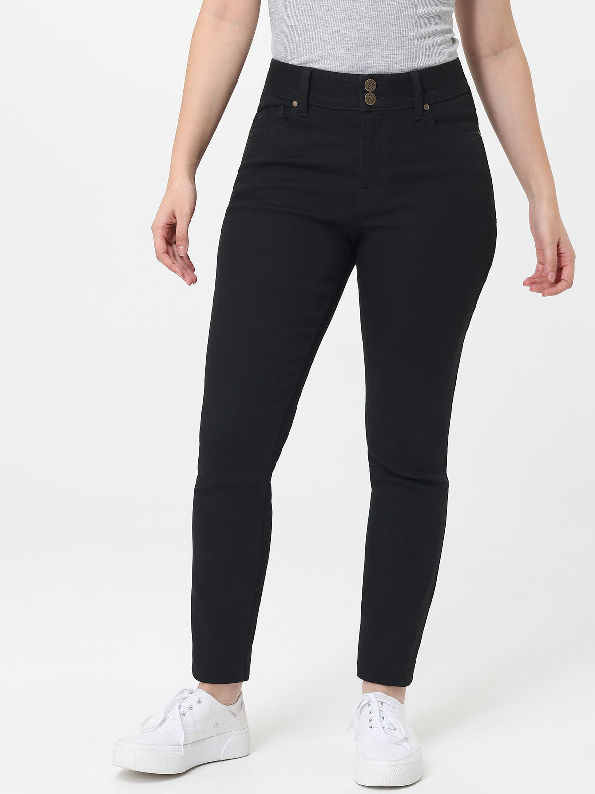 Person wearing black jeans on a white background