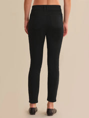 Person wearing black pants on a beige background