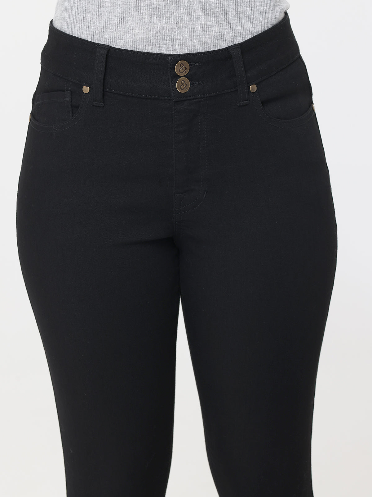 Black jeans with gold buttons on a white background