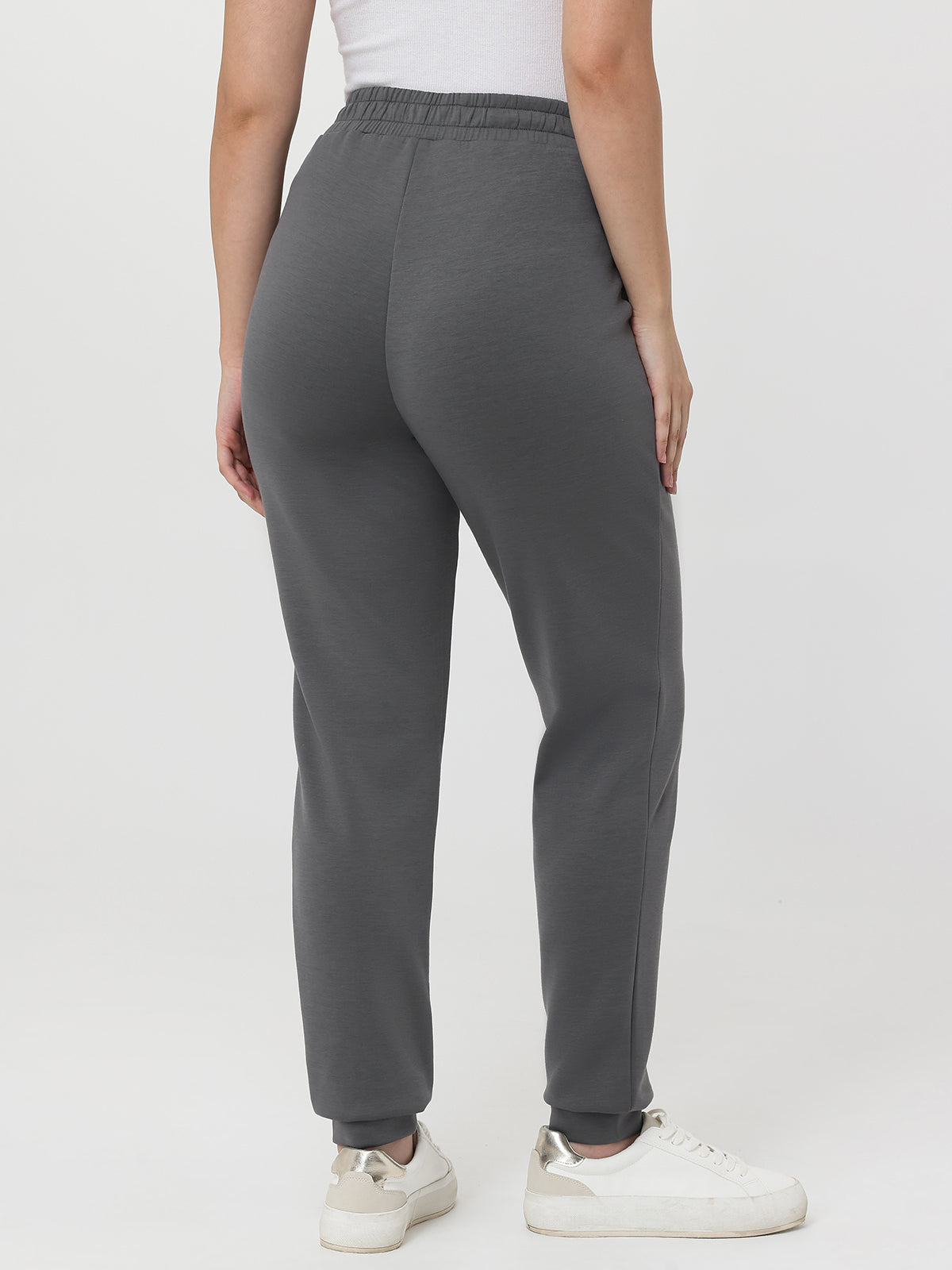 Person wearing gray sweatpants on a white background